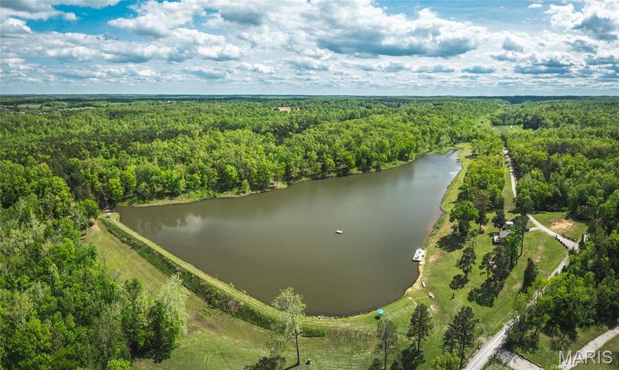 Carver Lake Lodge is a private 98.62 acre +/- retreat in Perryville, MO, featuring a stunning 17 acre +/- lake, 30-ft natural waterfall, and spring-fed creeks. Includes two lodges—“Taylor Lodge” (1,050 sq ft A-frame) and “Cash Lodge” (720 sq ft ranch-style)—each with 2 beds, 1 bath, full kitchens, and lake views. Enjoy excellent fishing, paddle boats, swimming, and hiking trails across the scenic, wooded landscape. The lake is stocked with bass and bluegill. A large shop provides ample storage for equipment and toys, along with additional smaller storage buildings. Wildlife is abundant, and views are second to none. Perfect for family getaways, vacation rental income, or your own private escape. Peaceful, secluded, and ready to enjoy—whether you’re relaxing on the deck, exploring the trails, or spending time on the water, Carver Lake Lodge delivers the kind of peace you won’t find just anywhere.