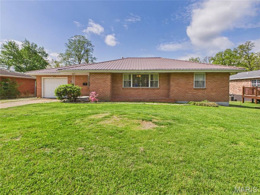 This classic brick ranch in Northwood Hills offers a rare combination of solid mid-century construction and incredible potential. Positioned on a gentle sloping city lot in Poplar Bluff, the home features a functional layout with 1,462 square feet of living space on the main level and a full walk-out basement that effectively doubles the usable area.

Key Interior Features
The main level consists of a comfortable living area, a separate dining room, and two bedrooms. A standout feature of this residence is the presence of original hardwood floors currently preserved beneath the carpets in the living room and bedrooms. These floors are ready to be uncovered and restored, offering a perfect opportunity to add immediate warmth and historic character to the home.

The fully finished basement significantly expands the footprint, providing four additional sleeping areas and a second full bathroom. This lower level is ideal for a large household, guest quarters, or a dedicated home office setup, complete with its own private walk-out access.