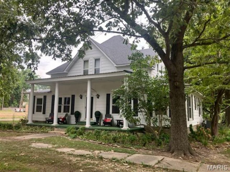 Older two-story home in the heart of Campbell, MO. This spacious property features 3 bedrooms and 1 bath upstairs, with all other living areas on the main level. The open-concept living room includes a gas fireplace and flows into the kitchen with eat-in area and separate dining room. Additional rooms include a den, sunroom, and laundry with commode. Situated on a corner lot, the home offers an attached two-car carport and a 2020-built shop with overhead door, walk-through door, and electricity. A partial wooden privacy fence adds outdoor appeal.