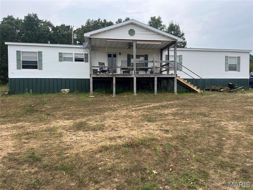 20 Acres with a 2040 Square feet 5 Bdrm. 3 bath manufactured home that has some great views overlooking the property of pasture and woods along with views over the country side. Also has a nice 30 x 40 horse barn with 5 - 10 x 10 stalls and hay storage area. Mostly wooded so wildlife cover for the deer and turkeys. New fence in 2014, 4 strands. New roof 2017. Wood burning fire place has not been used in several years. Not far from Lake of the Ozarks. Great area for equine enthusiast with state park trails and private owned riding parks close.