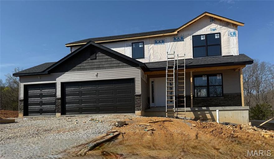 This Remington Model is under construction and will be complete by summer! 3 Bedroom 2.5 Bath 1768 sq. ft. 2 Story with main floor laundry and 2 Car Garage. Plans for exterior with black soffit, facia, gutters, windows, pillars, and garage door! The front will also feature stacked stone window sill height, shutters on the windows, and shaker siding in the gables. Luxury Vinyl Plank flooring throughout the first floor and all bathrooms. Kitchen with 42" cabinets and stainless steel appliances. Spindle banister. Primary bathroom includes adult height double sink. The new homes come with quality standard features & have additional options to choose from! The photo is a previous built home & may show optional features that are not included. Hawk Ridge Estates features 29 home sites with all back yards backing to woods. Located off Hwy B & Brickyard Road. With this being a smaller community lots may sell quickly, hurry today to secure your dream home!