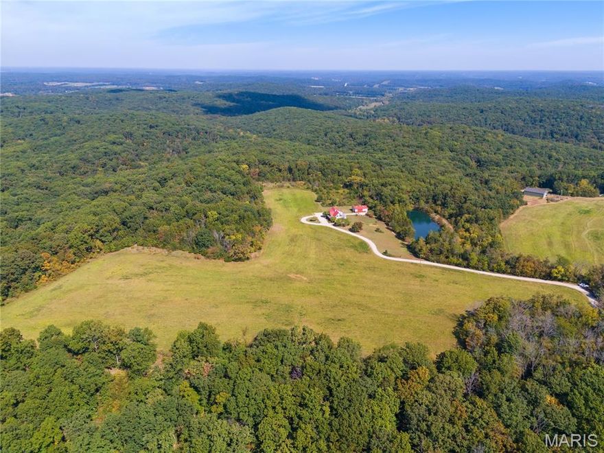 Absolutely gorgeous setting for this wonderful country home on 42 acres with a 1+ acre stocked lake, wonderful guest cabin/studio & 40x30 Morton Building barn. Less than 15 minutes to Hermann wineries & shops or on your bike at the Katy Trail in 10 minutes! Extraordinary custom timber frame home with beautiful views of woods, fields & lake. Original owner/architect designed; the home offers cozy rooms sitting by the 3 fireplaces (one on each floor). Updated kitchen boasts 2 pantries, one walk-in, quartz countertops & updated appliances. The primary bedroom offers a spacious walk-in closet & renovated bath. Enjoy a beautiful loft area (which could be 4th bedroom) & children's play room/library area. The open design offers plenty of light with large windows & sunny views. A finished lower level (included in total sq/ft) offers a bedroom & full bath, family room & plenty of storage. New HVAC 2022. Enjoy a cozy cabin by the lake, 2 docks, fishing and hiking! Duplicate listing of 25023431 Suitable for Bed/Brk