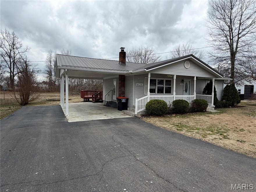 This two-bedroom, two-bathroom home in Advance features a neutral color scheme, hardwood floors, and crown molding throughout. The separate dining room includes a built-in china hutch and opens to an uncovered deck. The roof was replaced within the last ten years.