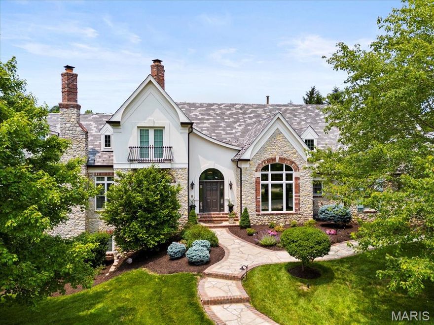 Nestled along the 17th hole of the Lewis & Clark Golf Course in the exclusive Cedars Valley community, this European-inspired manor offers a timeless blend of elegance, craftsmanship, & comfort. Spanning over 6,100 square feet, the home is designed for both refined living & effortless entertaining. Vaulted ceilings with exposed beams bring warmth & scale to the family room, while French doors open into a formal dining/piano room & the office featuring a spiral staircase winding up to a charming library. The heart of the home is a gourmet kitchen, masterfully equipped with William Ohs custom cabinetry, a Sub-Zero refrigerator, a 48” Wolf range, & thoughtfully designed storage. The primary suite serves as a true retreat, complete with a gas fireplace, steam shower, jacuzzi tub, dual vanities, & two walk-in closets. Each additional bedroom features its own en-suite bath & walk-in closet, ensuring comfort & privacy for family & guests alike. Downstairs, the lower level transforms into an entertainer’s dream with a fully appointed bar featuring an ice maker, refrigerator, & hammered copper sink. Outdoors, the home continues to impress with a flagstone patio, wood-burning fireplace, & landscape lighting that creates a magical ambiance as the sun sets over the fairway. Recent upgrades, including newer Pella windows & doors on the west side & custom Hunter Douglas silhouette shades, add to the home’s quality & efficiency. A spacious 4-car garage rounds out this exceptional offering.