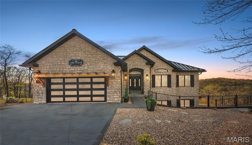 Tucked into a private setting in the heart of town, this stunning home offers year-round lake views and 3 acres with no HOA—perfect for relaxing, entertaining, or expanding. The spacious layout features 6 bedrooms, 4.5 bathrooms, two living areas, a safe room, and two laundry rooms. Enjoy two luxurious primary suites with spa-like baths and high-end showers. A standout feature is the versatile basement en suite, ideal for a guest suite, man cave, workshop, or creative space. Recent upgrades include new garage doors, fencing, ceiling fans, interior lighting, new granite on the kitchen island, a double oven and more. The finished, climate-controlled garage feels like an extension of the home, complete with modern finishes, dark accent walls, rich wood flooring, updated lighting, and built-in shelving—perfect for car enthusiasts or collectors. Level, usable acreage offers endless possibilities to add a pool, shop, or more. Luxury, privacy, and convenience come together in this rare property.