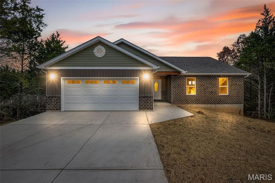 NOW IS THE TIME TO GET MOVING!  Welcome to your dream home in a stunning, Briarwood Estates, lake community! This brand-new ranch-style residence offers the perfect blend of comfort, style, and location. With approximately 1,600 square feet of thoughtfully designed living space, this home sits on a level lot and features a walkout basement.  The backyard backs to a serene line of trees, offering privacy and a peaceful natural view.  Enjoy this private oasis while sipping your morning coffee on the large back deck.  Located in a sought-after neighborhood, residents enjoy access to gorgeous community lakes with a swimming beach, perfect for summer fun and relaxation. Golf enthusiasts will love the nearby golf course, making this an ideal location for both leisure and recreation.  Step inside to discover a spacious open-concept floorplan with a vaulted ceiling in the great room, complete with a ceiling fan and light fixture that enhances the airy ambiance. The kitchen is a chef’s delight, featuring elegant pendant lighting, 42" cabinets, a stainless steel hood, and a pantry for ample storage. The breakfast room flows seamlessly into the kitchen and great room, making entertaining a breeze.
Stylish carriage-style doors are found throughout the home, adding a touch of charm and sophistication. Durable and beautiful luxury vinyl plank flooring spans the kitchen, great room, entry foyer, breakfast room, bathrooms, and laundry room—combining practicality with modern aesthetics.
The primary master suite is a true retreat, boasting a vaulted ceiling, a double window that fills the room with natural light, and a spacious en-suite bathroom with a double bowl vanity. Main floor laundry adds convenience to your daily routine and extra storage options.
The exterior of the home features a classic brick front and a two-car garage, providing both curb appeal and functionality. Whether you're enjoying the peaceful wooded backdrop from your backyard or taking advantage of the community amenities, this home offers a lifestyle of comfort and connection.
Don’t miss your chance to own this beautiful new construction home in a vibrant lake community.  This 3 bedroom, 2 bath brand-new gem is waiting for you so schedule your private tour today and experience the perfect blend of nature, luxury, and convenience!