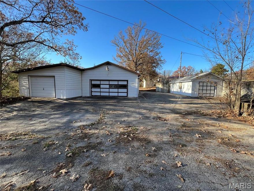 Unlock the potential of this unique multi-building property situated just off Historic Route 66 with quick and easy access to I-44! Offering excellent visibility and versatility, the first building features approximately 1,488 sq ft with multiple overhead garage doors, an overhead track system, a half bath, and 3-Phase electrical available—perfect for a workshop, small business, or creative workspace. The second building includes approximately 549 sq ft with its own overhead garage door and is ideal for a future apartment build-out, storage for rental supplies, antiques, tools, or even a boutique flea market setup. With utilities currently disconnected and the property being sold as-is, this truly is a blank canvas ready for your vision. Bring your ideas and transform this flexible Route 66 location into your next income-producing opportunity! Square footage and measurements are approximate (DSC-8001).