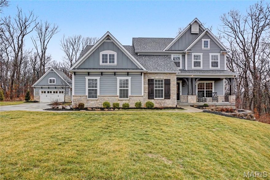 Set on 3 park-like acres, this traditional/craftsman style like-new home offers over 4,800 sf of living space with exceptional design, functionality and privacy.  9 ft ceilings and luxury vinyl plank flooring run throughout the main living areas, creating a substantially bright and cohesive feel from the moment you enter. 
Just off the front entry is a private office with glass French doors, ideal for working from home. The open floor plan features a spacious living room with custom built-in bookshelves surrounding a gas fireplace, seamlessly connecting to the kitchen and breakfast room. The kitchen is designed for both everyday living and entertaining, featuring a very large center island perfect for gathering, along with 2 ovens - one propane and one electric - offering flexibility for cooking and hosting. A stunning sunroom wrapped in windows fills the home with natural light and provides peaceful views of the wooded backyard. 
Step outside from the sunroom to a covered patio complete with a gas stone fireplace and built in sunshade, perfect for year round outdoor living. The backyard is charming and private, surrounded by woods and manicured character, and leads to a large stamped patio that extends to a detached 2 car garage that is both heated and cooled, offering excellent additional storage, workshop or hobby space.
The main-level primary suite features 12 ft ceilings and a luxurious bath with double vanity, standalone soaking tub and marble walk-in shower. Nearby is the main floor laundry with utility sink and additional storage and access to the attached oversized, extra-deep 2 car garage. 
Upstairs offers three additional bedrooms, two full bathrooms and a loft area, creating an additional lounge area.
The walk-out lower level adds incredible flexibility with a massive recreation room, a dedicated work-out room with mirrors, fan and carpet tile flooring as well as a 5th bedroom, 5th bathroom and a versatile room ready for any of your needs.  The unfinished utility area houses the dual geothermal HVAC systems and two 80-gallon water heaters, ensuring comfort and efficiency for the entire home.
The property offers the perfect blend of modern living, outdoor beauty and space to entertain, all in a peaceful setting with room to breathe. Located close to New Melle, Defiance or Augusta for small town fun and winery activities and still close enough to Wentzville or Chesterfield for all modern conveniences.
