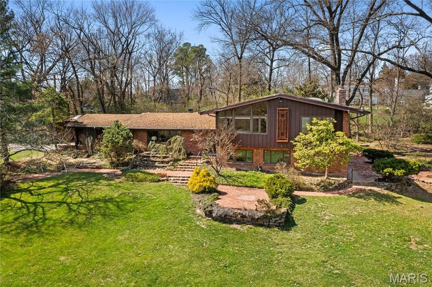 Nestled on 1.24 acres in the heart of Ladue, this private property blends generous space with the convenience of walking to Ladue High, Conway Elementary, MICDS, and nearby shops and restaurants. The split-level ranch offers more than 3,500 square feet of living space, featuring over five bedrooms, three and a half baths, a two-car attached garage, and an additional detached space. Step outside to beautifully landscaped grounds with a tranquil waterfall, goldfish ponds, and a spacious lawn complete with a tee box for practicing your golf swing. Inside, recently refinished oak hardwood floors are paired with new carpeting and fresh paint throughout. The kitchen is outfitted with custom cabinetry, granite countertops, and a cozy breakfast area that overlooks the garden. The walk-out lower level adds flexibility, with a family room with a fireplace, a bar area, a fifth bedroom, and a sixth bedroom or office option. An additional shed provides extra storage. Private road shared and maintained by only two homes.