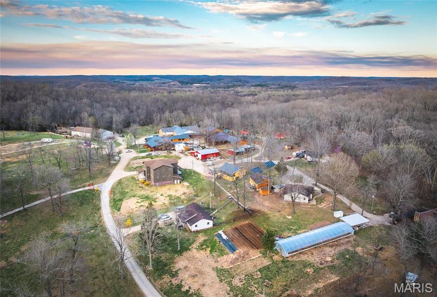 This beautiful property is located along Wayne 380, just northwest of Greenville. This property was formerly used as a school and ministry in the past but has endless possibilities. The schoolhouse contains a commercial kitchen, dining hall, locker rooms with bathrooms and showers, dorms, apartments, and multiple large rooms to fit any of your needs. A venue building is also on the property and is the perfect place to host parties and events. The gorgeous wooden home and seven other houses add to all the dwellings this property provides. A campground with twenty camping sites creates more space to host guests and visitors. This property has two shops, one containing an apartment, making it a great place to store all your tools and equipment. Corps of Engineers grounds border the property on two sides, and the Saint Francis River is less than a quarter mile away, making for great hunting and fishing opportunities. Call today to schedule your own private tour.