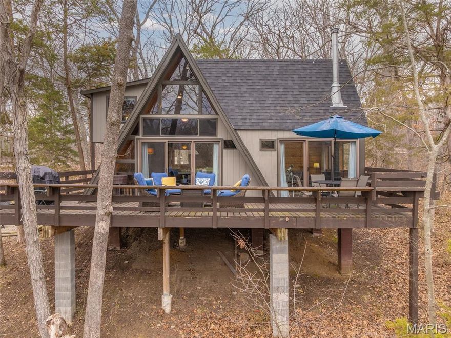 Your perfect Innsbrook escape with peaceful golf course views and treehouse-style living. This storybook chalet retreat features 2 bedrooms, 1.5 baths, and a sleeping loft, perfect for weekend escapes or entertaining guests. An adorable kitchen opens to the dining area and the large expanded great room, the heart of the home, featuring a cozy wood-burning stove, vaulted ceilings, beautiful millwork, and floor-to-ceiling windows that create a treehouse-like setting with beautiful views of the woods and the 3rd tee box. Enjoy an expansive deck and outdoor fire pit area, perfect for relaxing evenings under the stars.
Recent updates include new roof (2023), HVAC (2023), and septic tank (2023). A newer storage shed adds extra convenience. Offered completely turnkey, including a 2026 grill, two kayaks, and everything needed to make this home rental-ready or ready to enjoy from day one.
A truly special Innsbrook gem!