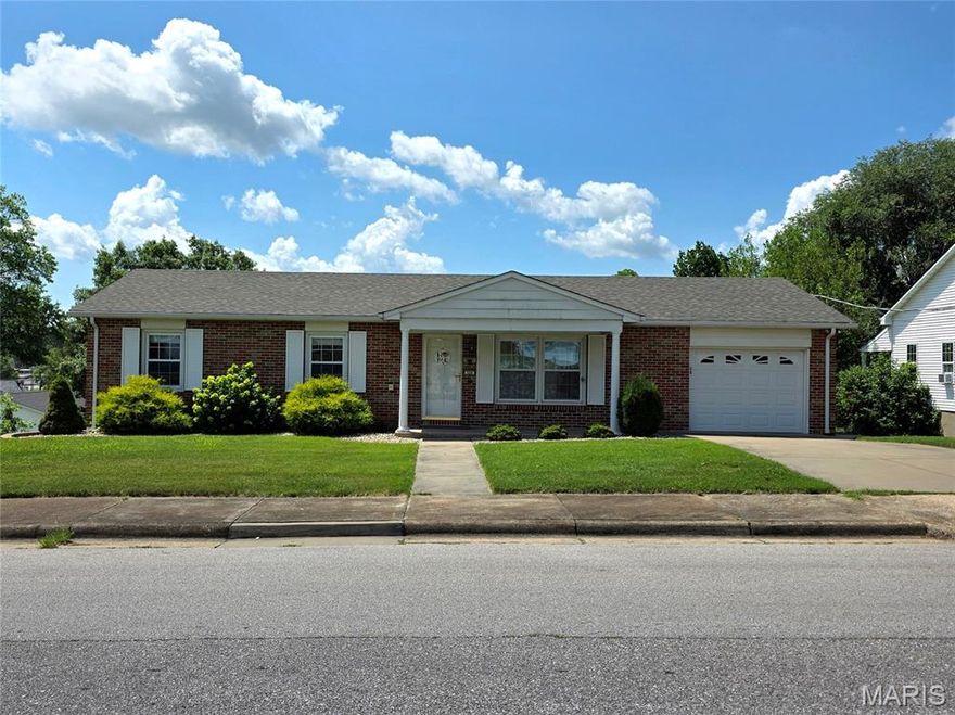 Here's you're chance to own this great find!  Attractive brick home with covered front porch and inviting curb appeal calls out "Welcome Home".   Step inside and you'll instantly feel at home.  Roomy living room greets you and boasts gleaming wood floors and plenty of natural light.  Kitchen is bright and cheery and offers the perfect place to whip up your favorite recipes.  Separate dining room is just off the kitchen.  Down the hallway you'll find 3 bedrooms and 2 full baths.  Full basement walks out to large, large back yard that backs to trees.  Make sure you put this one on your "Must See" list before it's too late.