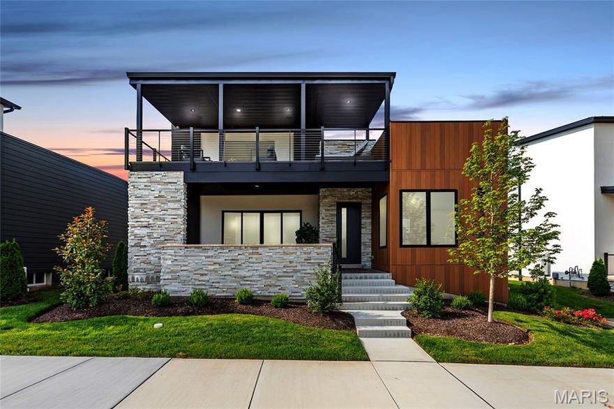 Experience elevated lakefront living in this spectacular, nearly new 1.5-story custom home located in Chesterfield's exclusive Waterfront at Wildhorse Village. With over 4,800 sq ft of curated living space, this 5 bed, 5 bath (4F/1H) residence showcases a sun-drenched open floor plan with 10' ceilings, wide-plank white oak flooring, designer millwork & dramatic lake views from nearly every room. Gourmet kitchen features high-end appliances, a Sub-Zero fridge, waterfall-edge island, floor-to-ceiling custom cabinets & fully integrated wine sommelier station. Main-level primary suite offers a private retreat with a spa-like bath, rainfall shower, soaking tub, dual vanities & custom closet. Upstairs includes a junior suite, two additional beds, another full bath, bonus room with wet bar and wine fridge & access to a covered lakeview deck. Finished lower level is built for entertaining with a second kitchen, custom bar, fitness room, bedroom, full bath & designer acoustic accent wall. Outdoor living is unmatched with a covered front lanai, second-floor deck & private courtyard featuring stone pavers, 8ft custom fire table & 145" triple weir waterfall. Additional features include a full smart home system, window treatments, security cameras, irrigation, professionally landscaped yard, tons of storage, and a 3-car garage with epoxy floors & custom cabinets. Located steps from walking trails, 2 lakes & minutes to premier dining, shops & hwys - this is luxury living redefined!