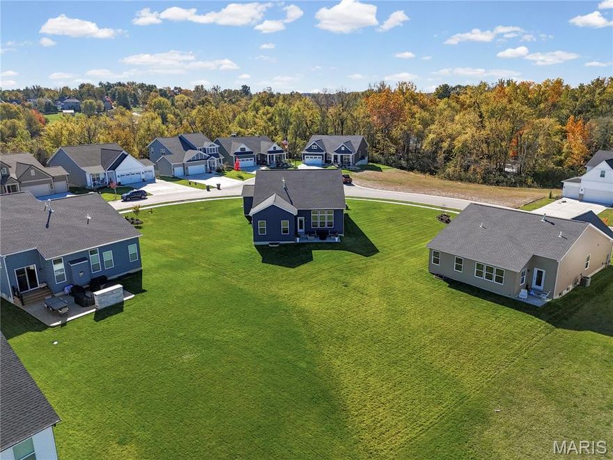 Imagine starting your day in a home that feels like a private retreat while sitting right in the heart of one of Missouri’s most charming and safest communities. This meticulous, two-year-old ranch in Cottleville Trails offers the rare luxury of a nearly half-acre lot, providing privacy between neighbors and a sense of tranquility that is hard to find in such a sought-after area. The interior is a masterclass in high-end design, centered around a bright white chef’s kitchen with a striking cobalt-blue backsplash and a professional gas range. Whether you are working from the dedicated home office or relaxing in the open-concept great room under soaring 11-foot ceilings, every inch of the custom floorplan has been thoughtfully modified for modern convenience, including motorized blinds and a perfectly placed guest half-bath. Living here means your lifestyle extends far beyond your property line into the vibrant, golf-cart-friendly culture that makes Cottleville so desirable. You can spend your afternoons cruising the neighborhood’s five lakes and miles of scenic trails, or take a quick cart ride to the historic Old Town District for award-winning dining and boutique shopping. Families specifically seek out this enclave for the top-rated Francis Howell School District and the peace of mind that comes with living in one of the state's most secure towns. With a primary suite featuring sleek luxury finishes, oversized 8-foot garage doors, and a massive basement ready for future expansion, this home perfectly captures the blend of sophisticated suburban living and the active, close-knit community spirit that defines the Cottleville experience.
