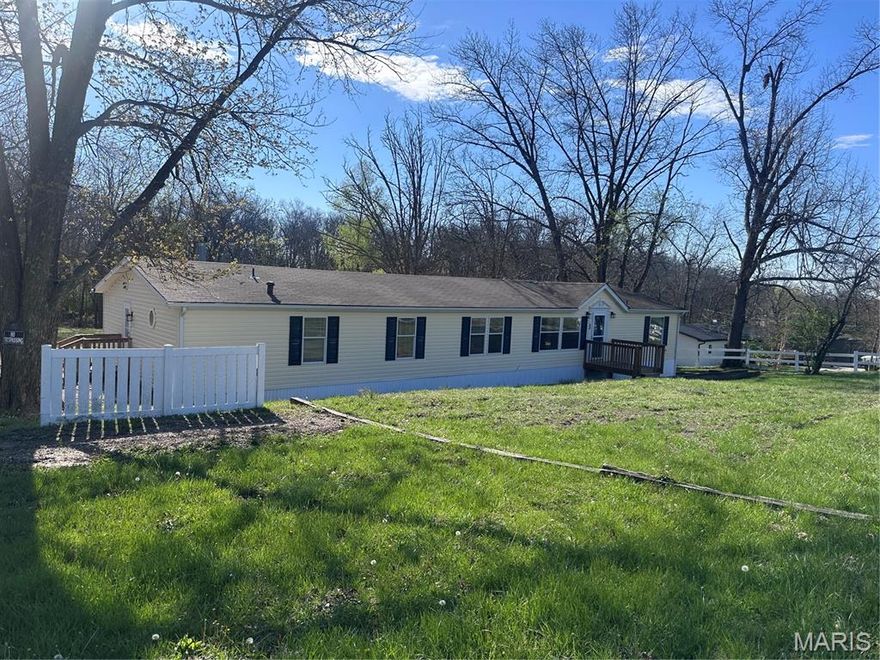 Looking for space, updates, and a great location? This 4 bed, 3 bath home on nearly an acre offers it all! Conveniently located off Hwy 47 between Troy and Winfield, this home features a split-bedroom layout and a spacious two-room primary suite with a spa-like bath including a jetted tub, separate shower, and double sinks. Cozy up in the family room by the wood-burning fireplace or enjoy cooking in the updated kitchen with new countertops and stainless steel appliances. With fresh paint, new flooring throughout, and a brand-new deck overlooking the large backyard and shed, this home is move-in ready and made for comfortable living.