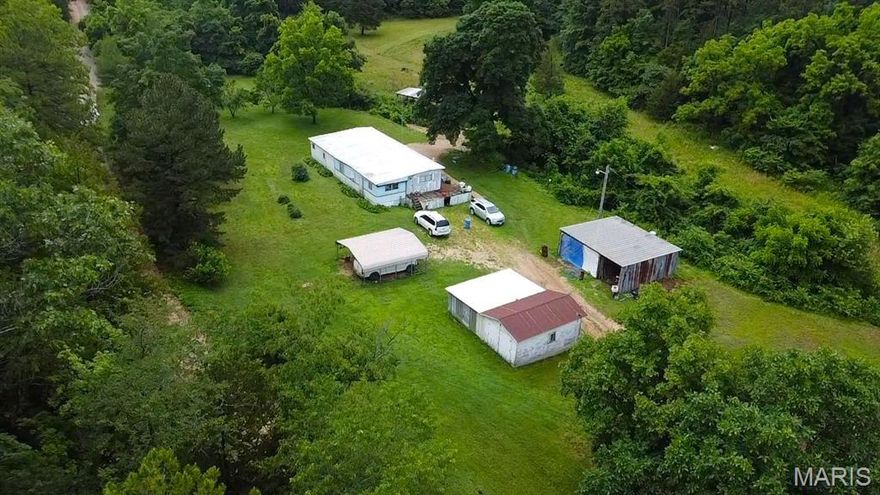 For the dedicated outdoorsman, this 44-acre property just south of Greenville, MO, offers the ultimate private retreat. Located off Highway A and bordered by government land, it provides direct access to thousands of additional acres for hunting, hiking, and outdoor adventure. This diverse tract features a blend of mature timber and open pasture - ideal for food plots, wildlife habitat, and ATV trails. The area is rich with deer and turkey sign, and the current owner has even spotted turkeys in the front yard. A seasonal wet-weather creek adds natural beauty and a reliable water feature for wildlife. The property is already set up for comfortable living or weekend stays, with a manufactured home serviced by a private well, a brand-new septic system, and a home generator for backup power. Whether you're looking to build your dream home, establish a hunting camp, or enjoy a peaceful escape, this land is ready to go. With marketable timber, essential utilities in place, and a location surrounded by public land, this is a rare opportunity to own a self-sufficient, recreational haven in the heart of the Ozarks.
