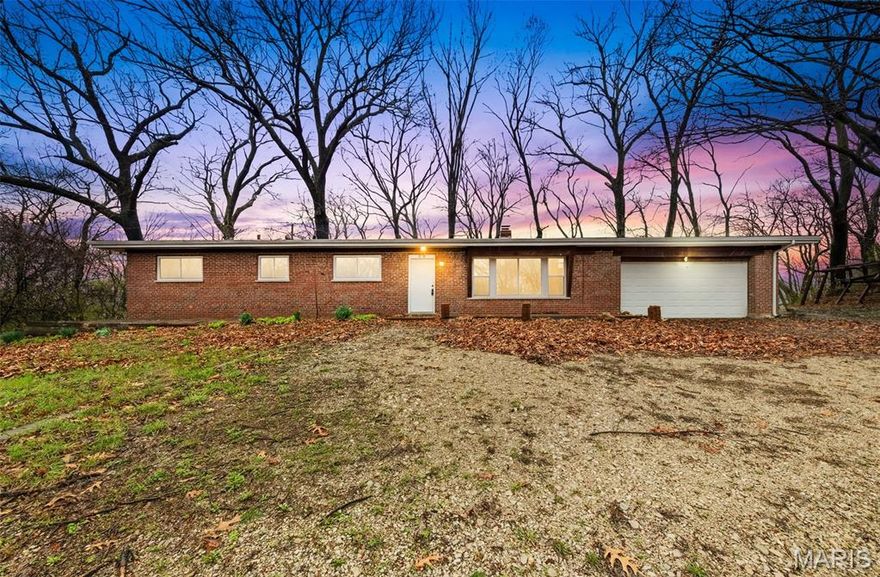 3 Private Acres! Wonderful views as far as the eye can see! Great Development opportunity! Tucked away on approximately 3 private acres, this brick home offers peaceful seclusion with breathtaking views overlooking the Missouri River Valley. Surrounded by trees, the property provides the perfect balance of privacy, open space, and natural beauty. Also making this lot a phenomenal development opportunity! Inside features 4 bedrooms and 1.5 bathrooms along with an attached 2-car garage. The spacious living room welcomes you with abundant natural light pouring through the large front window and is highlighted by a beautiful stone wood-burning fireplace, creating a warm and inviting focal point. The adjoining kitchen provides generous cabinet storage with custom wood cabinetry, plenty of counter space, and a large center island with breakfast bar seating. The primary bedroom is located down the hall and includes its own private half bathroom and large closet. Three additional well-sized bedrooms each offer ample closet space and share a full bathroom featuring ceramic tile and a spacious vanity with extra storage. Step outside to an oversized patio overlooking the scenic surroundings — an ideal space for relaxing, hosting guests, or simply enjoying the peaceful countryside. The backyard is also partially fenced for added convenience. SOLD AS-IS!