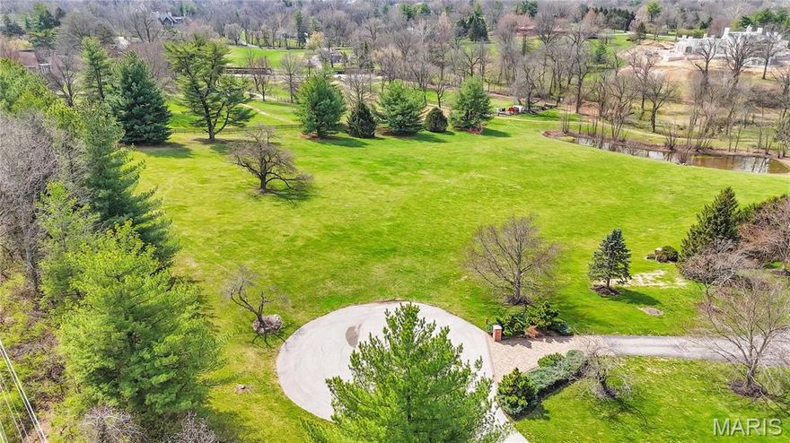 Beautiful estate home site on 4.46 acres in Huntleigh. Exceptional lot in a park-like setting for building your dream home.
