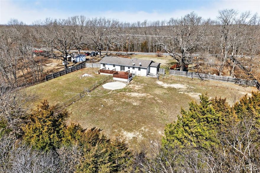 Exceptional 40.5-acre property just 15 minutes from Lebanon offering the perfect blend of rural privacy, agricultural functionality, and everyday comfort. The land is thoughtfully set up with multiple cross-fenced paddocks, a large pond, and a metal livestock shelter featuring two gated stalls—ideal for livestock or hobby farming. A new well house water tank (2025) adds additional peace of mind.

Inside, the home offers a spacious and practical layout with no carpet throughout, featuring durable flooring for easy maintenance. The oversized living area provides an open feel with abundant natural light. The kitchen is designed for functionality with generous counter space, stainless steel appliances, a new dishwasher, and a large center island with sink and dishwasher—offering plenty of prep space and room for gathering.

A standout feature is the bonus room with exterior access directly to the paddocks, plumbed with hot and cold water. This versatile space offers endless possibilities including a home-based salon, craft room, pet grooming business, mudroom, livestock care area, or canning and garden prep space. With its separate access and utility setup, this room provides exceptional flexibility for rural living or small business potential.

The primary suite includes a walk-in closet, and both bathrooms feature updated tile showers for a clean, modern feel.

Additional amenities include a detached one-car garage with lean-to covered space for equipment storage, a charming tree house with two swings, and an established garden filled with lilac bushes, white and purple irises, peonies, and lily of the valley. This property delivers usable acreage, practical improvements, and comfortable living all within convenient reach of town.