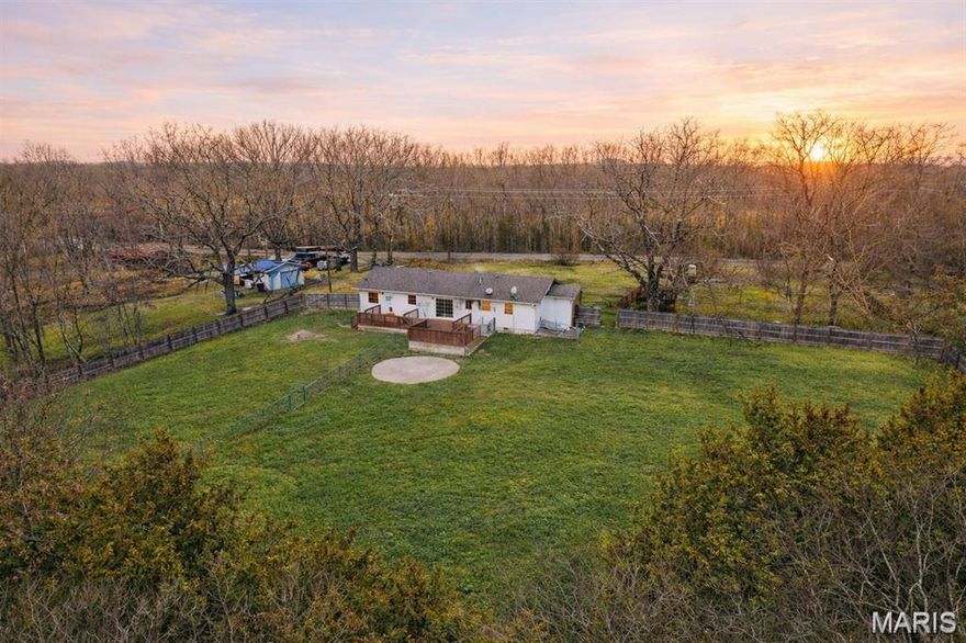 Exceptional 40.5-acre property just 15 minutes from Lebanon offering the perfect blend of rural privacy, agricultural functionality, and everyday comfort. The land is thoughtfully set up with multiple cross-fenced paddocks, a large pond, and a metal livestock shelter featuring two gated stalls—ideal for livestock or hobby farming. A new well house water tank (2025) adds additional peace of mind.

Inside, the home offers a spacious and practical layout with no carpet throughout, featuring durable flooring for easy maintenance. The oversized living area provides an open feel with abundant natural light. The kitchen is designed for functionality with generous counter space, stainless steel appliances, a new dishwasher, and a large center island with sink and dishwasher—offering plenty of prep space and room for gathering.

A standout feature is the bonus room with exterior access directly to the paddocks, plumbed with hot and cold water. This versatile space offers endless possibilities including a home-based salon, craft room, pet grooming business, mudroom, livestock care area, or canning and garden prep space. With its separate access and utility setup, this room provides exceptional flexibility for rural living or small business potential.

The primary suite includes a walk-in closet, and both bathrooms feature updated tile showers for a clean, modern feel.

Additional amenities include a detached one-car garage with lean-to covered space for equipment storage, a charming tree house with two swings, and an established garden filled with lilac bushes, white and purple irises, peonies, and lily of the valley. This property delivers usable acreage, practical improvements, and comfortable living all within convenient reach of town.