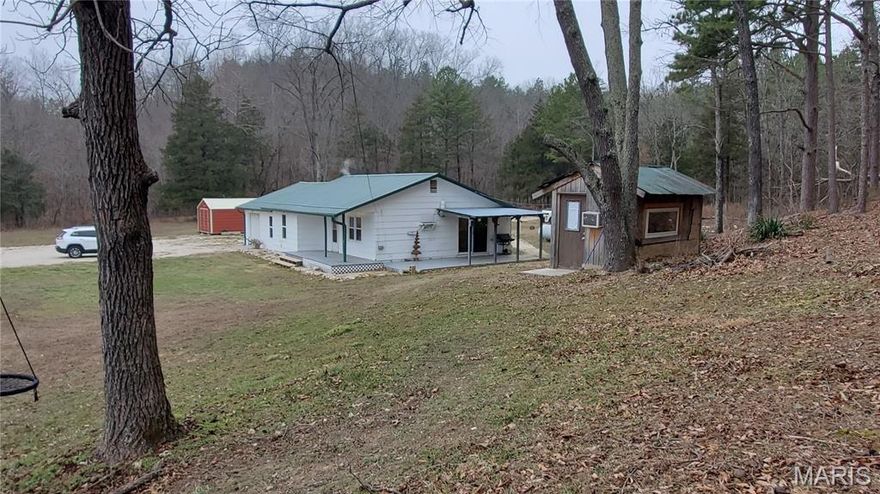 Clean and neat 3 Bedroom home with lots of extras. Beautiful 1.9 Acres including large storage shed and well house with addition having A/C for a playroom. Inside is eat-in kitchen, good size living room, spacious bedrooms and good size utility/mud room. Front porch and side patio covered. Heating and cooling new this last summer. Newer windows and door. Additional insulation recently. 2 year old well pump. Newer roof and gutters. At the top of the hill is a open area for building that small cabin because the view is fantastic. Not perfect yet - does need a little TLC.