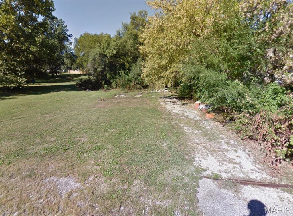Expansive land parcel featuring a mix of mature trees and open grassy areas
