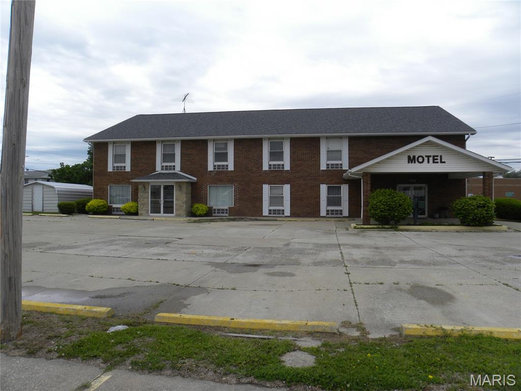 View of property with uncovered parking