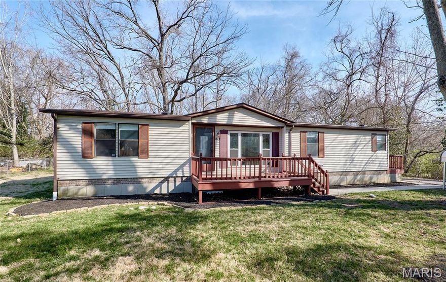 Affordable and adorable home in Fenton, MO!! This 3 bed/2 full bath home is ready for anyone wanting to move right in! Home has been lovingly updated with newer vinyl plank flooring and carpeting. Upon entering you'll notice the vaulted ceilings and wood burning fireplace. Primary bedroom is spacious with private bath including a separate shower and soaking tub. Second bedroom has walk-in closet. Dining room and kitchen have plenty of room for entertaining and cooking. Outside there is a wrap around deck that overlooks the level backyard with tree line which has lots of privacy especially in the late Spring and Summer. And, car port offers shelter for your cars. New roof in 2025!