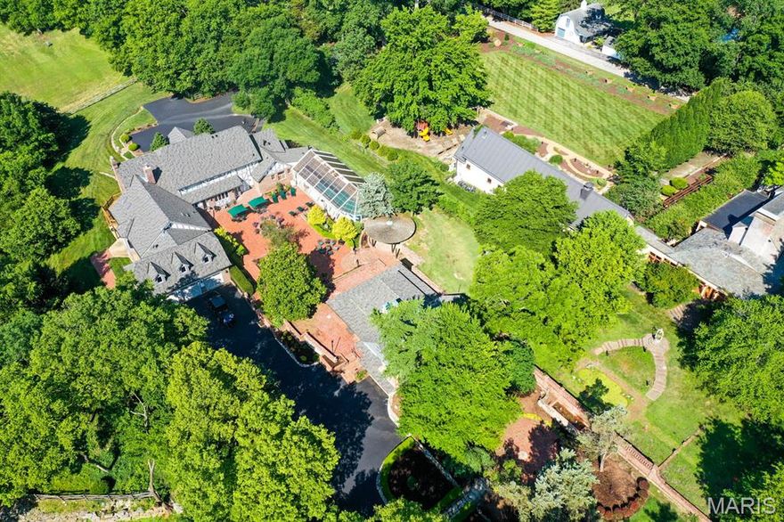 Description: This 9-acre sanctuary offers space for every part of life. The nearly 9,000-square-foot main residence blends timeless craftsmanship with modern comfort, balancing grand entertaining spaces with cozy family living. Crafted with 22 tons of oak timber joined by wooden pegs, a detail nearly impossible to duplicate today. The home is a true work of art designed to last for generations. Inside, you’ll find seven bedrooms, six full bathrooms, and a half bath, along with welcoming gathering rooms, three fireplaces, and a flowing kitchen that anchors the home.

The walk-out lower level provides a complete living space of its own, with a full kitchen, two bedrooms, two full bathrooms, and expansive areas for entertaining, exercise, games, or wine tasting in your private cellar. A walk-in safe adds yet another touch of distinction.

Beyond the main residence, the estate includes a separate guest house that functions beautifully as an office, suite, or meeting space. With two bathrooms, a fireplace, and a single-car garage, it also boasts an architectural addition designed in the style of William Bernoudy, apprentice to Frank Lloyd Wright.

Outdoors, Vallevue continues to impress with eight acres of fenced pasture, a horse barn, and abundant wildlife. From the home’s many windows and decks, it’s not unusual to see deer and wild turkey wander across the grounds, reinforcing the sense of peace and privacy.

Vallevue is more than a home—it’s a lifestyle of privacy, sophistication, and everyday escape, offered in one of St. Louis’s most desirable locations.