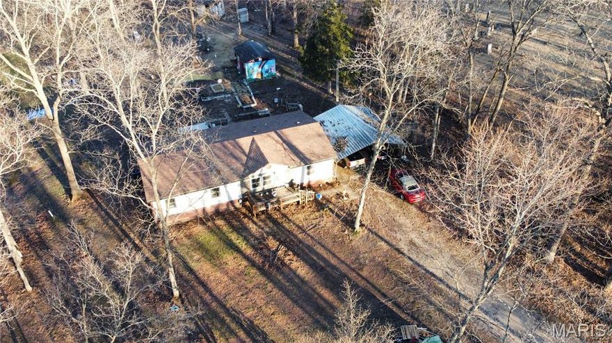 Looking for a place to get away and lots of privacy on blacktop? Then this is your house on 6.08 Acres.  3 Bedroom, 2 Bath, Open Floor Plan with a front and back deck. Wooded topography with wildlife running wild.  Lane leads you to the house but cannot see home from road. Lots of improvements including as of 2021- new roof, subfloors, floor coverings, new plumbing throughout the home, new bathtub and showing in 2nd bath. New shower, tub, sinks/vanities, and toilet in primary bath. new HVAC system installed and duct work. Carport and detached sheds. Trails through the woods. Come take a look!