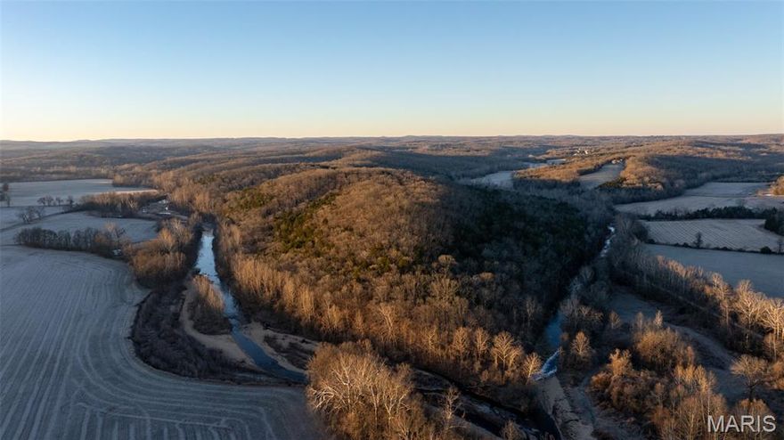 Here’s a rare opportunity to own 302 more/less acres in Jefferson County, Missouri, just east of DeSoto and Highway 67. This remarkable multi-use property boasts more than a mile of combined frontage along Flucom and Plattin Creeks, offering a mix of scenic beauty, privacy, and both recreational and investment potential. A gated entrance with privately owned access from the blacktop on Flucom Road welcomes you in, and a well-established rock road winds through the property, connecting to an existing trail system that’s perfect for your side-by-side or ATVs. Electric service already extends deep into the property, simplifying future plans for a home or cabin. Across the acreage, you’ll find multiple secluded build sites with spectacular panoramic views of rolling terrain, creeks, and bottom ground. Unique rock formations and dramatic bluffs add character and visual appeal, creating a truly special setting for a private retreat or legacy property. There’s abundant wildlife habitat here, with plenty of deer and turkey sign throughout the property. Several cleared food plot sites are already in place, making the land attractive for wildlife management and recreational hunting. Just 10 miles from DeSoto, 3 miles from Highway 67, and only 45 miles from St. Louis, this 302 m/l acre tract offers a rare combination of seclusion and accessibility. Whether you’re searching for a premier hunting property, a private estate, or a long-term land investment, this property checks all the boxes.  Property to be auctioned and sold as-is.  Auction will be held January 19th 2026 Live in person with online bidding as well. No buyer premium.   Property is gated, do not enter without confirmed showing. List price does not reflect final sale price.