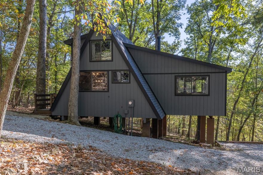 Rare opportunity to own a turnkey, income-producing waterfront chalet situated directly on Lake Solitude in the heart of Innsbrook Resort. This charming 1-bedroom, 1-bathroom chalet with loft is approximately 1,200 sq. ft. of thoughtfully updated living space and is currently operating as a successful short-term rental under professional management by Innsbrook Vacations, offering an investor-ready asset with an established booking history and outstanding guest reviews. Step inside the Chalet to find soaring vaulted ceilings and a warm, inviting living area anchored by a wood-burning fireplace. The main level features a private primary bedroom with a queen-sized bed and sliding glass doors opening directly to a screened-in porch, providing scenic views of Lake Solitude. The upper loft accommodates additional guests with three double beds, making this chalet ideal for families and entertaining. The fully equipped kitchen boasts custom cabinetry and stainless steel appliances, perfect for extended stays and family gatherings. This property has been meticulously maintained and significantly upgraded. In 2021, the owners completed a comprehensive renovation package including: new roof, new James Hardie fascia, new kitchen cabinets, new luxury vinyl plank flooring throughout main floor, new water heater, new septic tank, new seawall and landscaping, including a fire pit area, private beach, and walkway from the Chalet to the outdoor features. In 2023, the main water supply line to the chalet was replaced, ensuring long-term structural integrity and peace of mind for the next owner. The private outdoor experience is exceptional. An expansive deck overlooks Lake Solitude, views of dense Missouri hardwoods, and features outdoor furniture and a gas grill. The newly constructed fire pit area and the private beach provide multiple gathering spaces to create memories to last a lifetime. A private dock and beach, with direct lake access, round out a truly complete waterfront package. Currently enrolled with Innsbrook Vacations — the resort's established, professional short-term rental management company — this chalet benefits from a full-service management model including booking, guest communications, housekeeping, and maintenance coordination. Strong guest reviews reflect consistent satisfaction and repeat visitation. The property is move-in ready as a primary residence, second home, or seamless continuation as a short-term rental investment. Owners and guests enjoy full access to Innsbrook's world-class resort amenities including: 150+ acre Lake Aspen, seasonal swimming pool with lazy river, 18-hole golf course, driving range, fitness center, 7 hiking trails, tennis and pickleball courts, basketball courts, outdoor amphitheater, Clubhouse Bar & Grille, children's playground, community beaches, seasonal boat rentals, and the Country Market and Aspen Café. Don't miss this rare combination of waterfront lifestyle, substantial recent capital improvements, and immediate rental income potential in one of Missouri's most beloved resort communities.