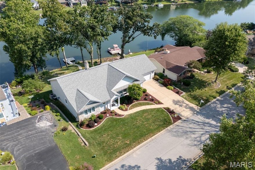 Water Front! Agent Owned. Main level 2905 sq ft per appraisal, lower level 2296 sq ft fin. per appraisal. This walk out Ranch is situated on Lake St Louise with a private dock and expansive views from most windows. The Open floor plan offers a great room with 11 ft beamed ceilings, floor to ceiling stone surround fireplace, a large kitchen/breakfast room with gas down draft stove with convection oven, a second oven with a warming drawer, granite counters and large walk-in pantry. The spacious master bedroom has a walk-in closet, second closet, a master bath with double sinks, separate tub and shower. The finished lower level has the 4th bedroom, a family room with a fireplace that is see through to the entertainment/game room. There is a large bar with granite counters, sink and open to game area and family room. Priced below appraised value!