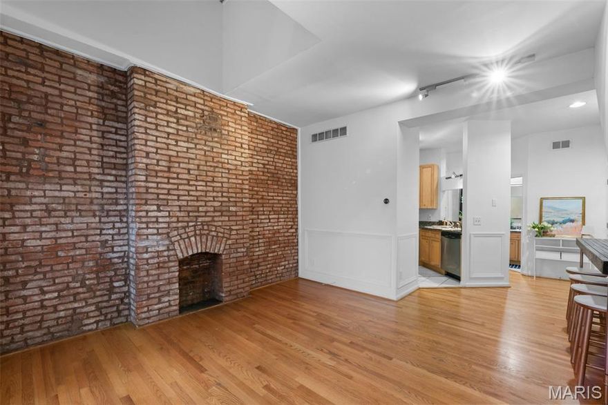 Live where charm meets city energy in the heart of Lafayette Square!  This darling 2 bed, 2 bath condo puts you steps from your favorite neighborhood shops, delicious dining, and the picturesque Lafayette Park.  Inside, the main floor welcomes you with soaring tall ceilings, classic wainscoting, large windows, and an exposed brick wall that brings all the character and cozy vibes.  This home blends historic charm with thoughtful updates.  The kitchen shines with stainless steel appliances and granite countertops. The home is equipped with a Ring camera and doorbell, a Nest thermostat, and is hard wired for a security system if you choose.  Along the wall in the living space there is a custom bar-height table designed to fit the space perfectly, adding both style and convenience for dining or entertaining.  The main floor bedroom features a walk-in closet and a custom Murphy bed framed by built-in shelving, perfect for hosting guests or a flex space.  You'll also find a full bath on the main level for added convenience.  Just off the bedroom, you'll walk onto the deck where you can relax after a long day! Upstairs is the second bedroom, full bath, and a stackable washer and dryer for everyday convenience.  This home comes with a dedicated single car garage spot with an opener and large storage unit. As an added bonus, enjoy the fully secured courtyard featuring a community garden where you can grow something special for your neighbors or simply grab a fresh ingredient when your salad needs a little something extra.  Stylish, walkable, and full of personality, this is a wonderful opportunity to call Lafayette Square home.