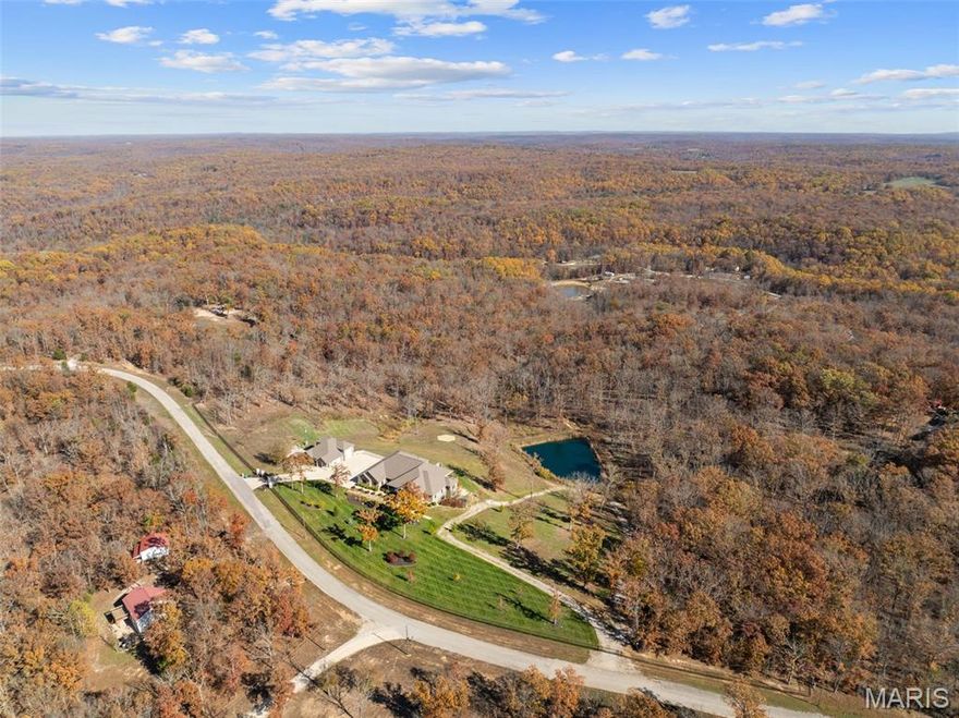 WOW this is an incredible property! This is a showstopper of a house on 17+/- beautiful acres with an approximate 1 +/- acre stocked pond with fountain. The owners have recently added new carpet, freshly painted walls, added security cameras and updated many more small details to add even greater beauty and quality to an already stunning home. The lower level has complete kitchen area to make a total independent living area. There is a large separate brick garage, RV garage with office area and entertaining/shop area with 1/2 bath. The property has been beautifully re- landscaped with a fabulous, gated entrance and specialty fencing. There are so many updated and incredible features in this house that you forget that you are in a beautiful and fun small town surrounding known for all of its outside recreational activities. This property has every AWE factor that there could possibly be. Wood floors, special cabinets, Anderson Windows, etc. etc.