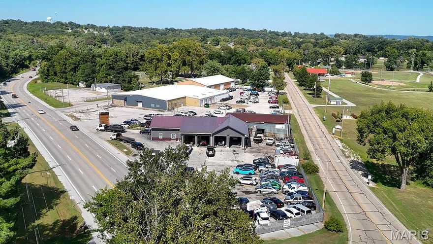 Location, Location, Location! Don't miss out on this amazing property! Prime commercial real estate situated in high visibility/ high traffic area right on US Highway 61! The building offers 3,000sq ft of shop area and another 900sq ft of office space. This property has 4 garage bays and ample parking with fencing.  There is a heated flooring system in the newer larger size garage. The main office space has a customer check-in area as well as a separate large office and a full bathroom.  There is also a kitchen/breakroom and another open space that could be used for storage or an additional office space. Heating and cooling via Mini-split systems. Minimal maintenance with the metal siding on the exterior.