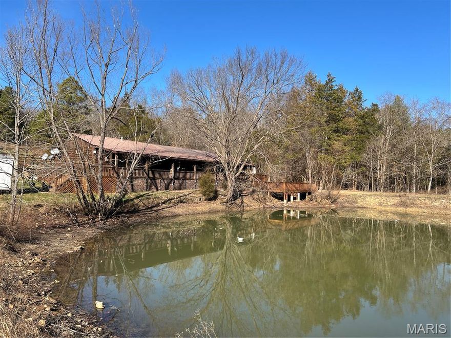 Absolutely Awesome Cedar Home! Escape to this charming rustic retreat featuring a super sharp crafted cedar home nestled on approximately 21.5 +/- picturesque acres. Warm and inviting, with a gorgeous wood burning fireplace in the living room. Enjoy peaceful country living with two private ponds, including one right in front of the home, perfect for fishing straight off your full-length covered front porch/deck, and a lower extended deck that goes out over the waters edge. The setting is ideal for relaxing, entertaining, and soaking in the natural beauty that surrounds you. The property is well-equipped with a metal roof, a very nice storage shed/workshop with workbenches, plus a chicken coop, and an extra coop.  Also pen for those looking to embrace a hobby farm lifestyle. A second homesite offers excellent potential for an additional residence or mobile home. Recent updates provide peace of mind, including a newer 85% efficiency heat pump HVAC system. The home also features a Generac generator, adding extra security and convenience.  Inside, you’ll find a relaxing primary bedroom and with a beautiful whirlpool tub, along with a functional mudroom and Ring alarm system already in place. There is a kitchen island/breakfast bar, with a combo dining area that opens up to a beautiful living room where you can enjoy the decorative rock fireplace. Located just 1.5 miles from Des Arc City limits, 12 miles to Piedmont, and within an hour drive to Poplar Bluff and Farmington. Outdoor enthusiasts will love being minutes from the Black River K Bridge area, Clearwater Lake, Johnson Shut-Ins State Park, and Elephant Rocks State Park.  Conveniently situated approximately 2 hours south of St. Louis and 1.5 hours west of Cape Girardeau, this one-of-a-kind property offers the perfect blend of privacy, recreation, and accessibility. This home is a Must See!