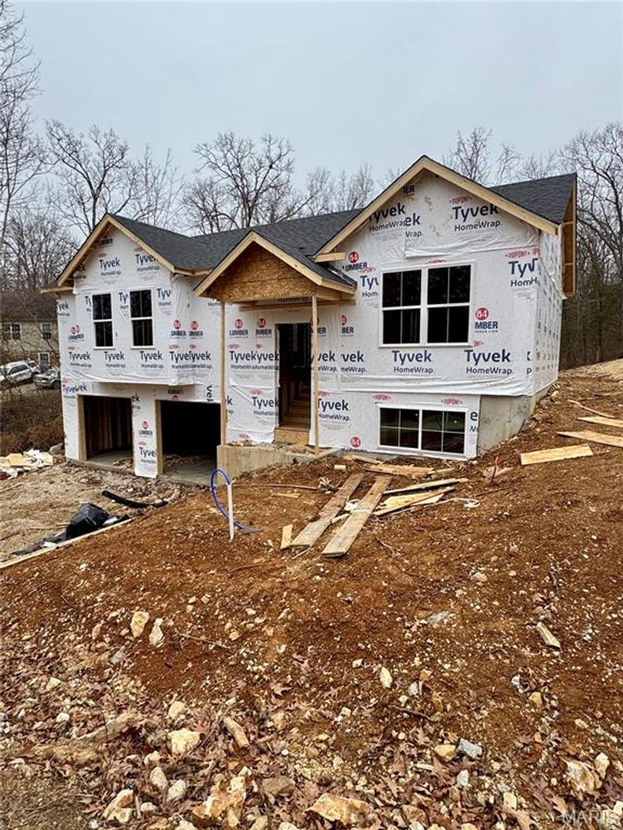 Under Construction- This astonishing modern take on a split foyer will feature 3 bedrooms and 2 full bathrooms. The foundation is poured, house is framed, and roof is on! Just a few months until completion, come add your finishing touches! Yes you read that correctly get into a new construction home without the 5-6 month waiting time! Board and Batten siding across the entire front of the home. Over 1,250 square feet on the upper level. The primary bedroom will feature a walk-in closet as well as a on suite primary bathroom. The lower level is to be unfinished with 500+ square feet of additional living space potential. 1/2 bath to be roughed in by the builder. Builder is willing to make adjustments to build finishes/ add ons depending on the stage of the build the buyer enters into contract in. No completed areas of the home will be re-finished to buyers desired trim level. Walk outdoors from the garage. Deck will be added off the back of the home. Photos are a rough idea of the finished product. Subject to change depending on elevation of the lot.