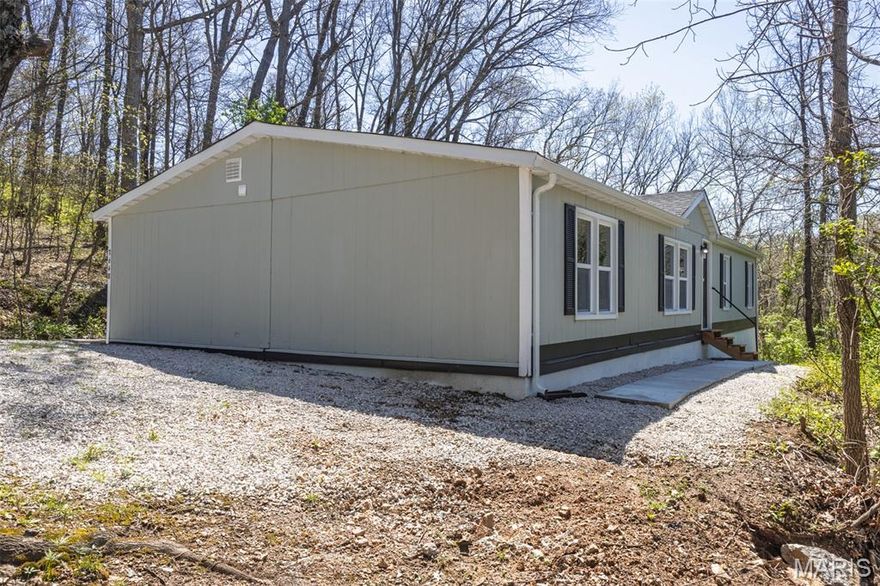 This spacious, move-in-ready 3-bed, 2-bath manufactured home, built in 1994, has been updated inside and out  with fresh paint, fixtures, appliances, flooring, heating, cooling, and more. This stunning property, nestled high on a hill surrounded by trees, has a  spacious lower leveled yard. You could utilize the  existing driveway  for the lower level to bring in additional income with a rental home, office, workshop, or hobby shop, empowering you to turn your passions into a career, giving you a balanced blend of tranquility and opportunity. This property is eligible for homepath financing.  This is a Fannie Mae homepath property.