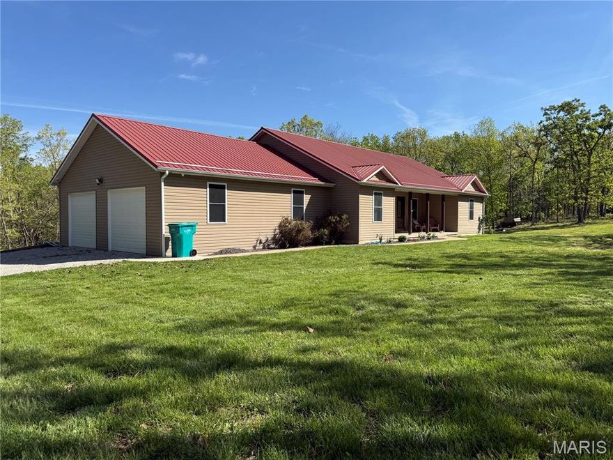 Built in 2017, this oversized 3-bedroom, 2.5-bath home sits on 9 beautiful acres, offering the perfect balance of privacy and convenience just minutes from town with a true out-of-town feel.

Inside, you’ll find hardwood floors throughout the main living areas and a spacious, functional layout designed for both everyday living and entertaining. The custom kitchen features granite countertops and quality cabinetry, and flows seamlessly into the living area where a matching custom built-in tying the space together with a cohesive, high end feel.

The master suite is a true standout, offering a massive walk-in closet and a stunning bathroom with detailed tile work, double vanities, a soaking tub, and a stand-up shower designed to feel like a private retreat.
The main bathroom also features a double vanity, providing added convenience and functionality for family or guests.
The partially finished basement expands your living space with a room currently used as a workout room, multiple storage areas, and additional room to finish out as desired.
An oversized 2-car attached garage provides everyday convenience, while the large back deck creates the perfect place to relax or entertain while overlooking your acreage.
Homes offering this combination of acreage, modern construction, and custom finishes this close to town don’t come available often.
Call today to schedule your showing!