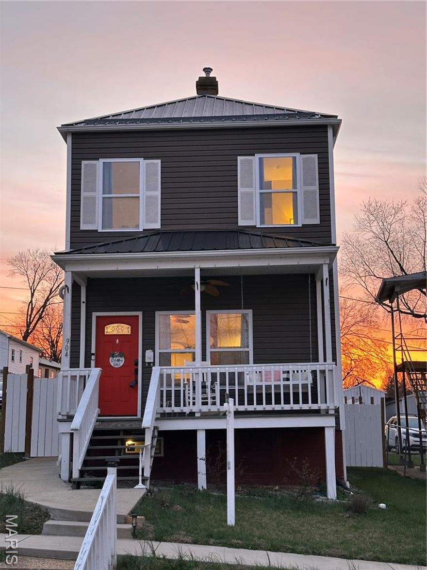 Highlight of the block and impossible to miss, this modern craftsman steals the curb appeal show with its bold red door, crisp white trim, and sleek metal roof! Step inside and you’ll instantly love the character-meets-clean-lines vibe. Exposed brick adds warmth, while bright white cabinetry, stainless steel appliances, and a generous center island anchor the updated kitchen. The open layout flows effortlessly into the living space, complete with custom built-ins that frame the perfect TV wall.  Main floor laundry + full bath = everyday convenience done right! Upstairs, you’ll find two spacious bedrooms including a private primary suite with full bath. Neutral finishes, great natural light, and truly move-in-ready condition make this an easy yes for first-time buyers. Outside, enjoy the covered front porch (coffee spot secured), a fully fenced yard perfect for kids and furry kids alike, plus a poured patio and sidewalks connecting front to back for easy, low-maintenance living. And the location is amazing! Walk to downtown De Soto’s cute shops, local dining spots, and nearby churches. Stylish. Efficient. Adorable. If you’ve been waiting for the one that feels different than everything else on the market . . . YOU JUST FOUND IT!