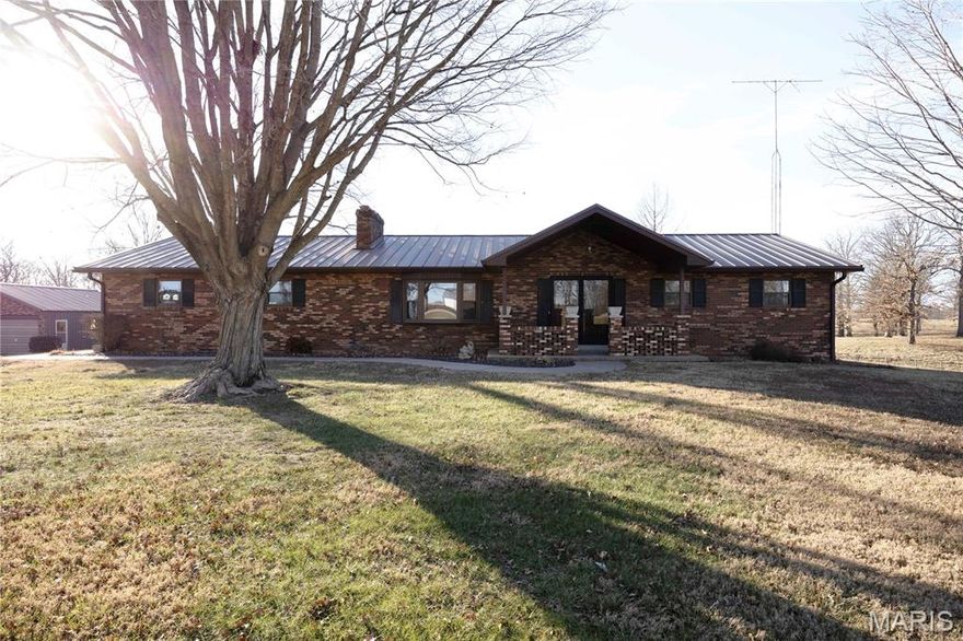 Located just outside the city limits of Perryville, this all-brick 3 bedroom, 2 bath home offers the perfect blend of space, privacy, and convenience. Situated on just over 3 acres m/l on the north side of town off Highway 51, the property provides a peaceful setting while remaining only minutes from all Perryville amenities.

The home features approximately 2,290 square feet of living space with a walk-out basement and an additional bathroom area already plumbed in the basement for future expansion. Recent updates include a new HVAC system throughout the home and extensive new plumbing work. A durable metal roof adds long-term value and peace of mind.

Outside, you’ll find exceptional storage and workspace with a 30x50 shop with concrete floor and a 26x32 detached garage with concrete floor, offering a total of four garage spaces. Enjoy the large yard, a great area for a garden, and a very nice back patio with a scenic view — perfect for relaxing or entertaining.

This property offers a fantastic location, generous acreage, and ample space both inside and out — ideal for those seeking room to spread out just outside of town.