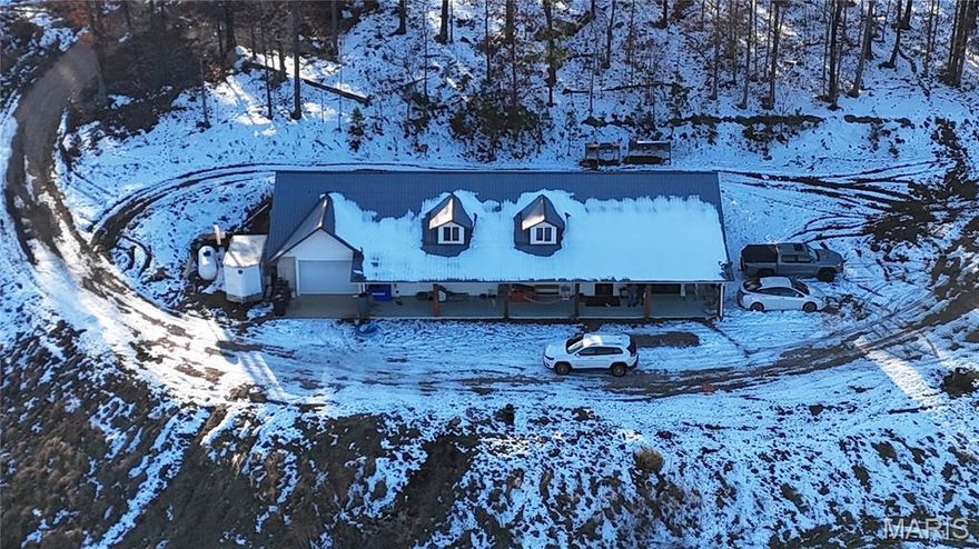 Located between Salem and Eminence is this Ozark hilltop beauty on 26 peaceful and secluded acres just minutes from Echo Bluff State Park, Sinking Creek, Current River State Park, Devils Well and Alley Springs, just to name a few. This home faces east and is nestled into the side of an Ozark hilltop, offering breathtaking views and picture-perfect sunrises. This beautiful retreat features a large open floor plan with 3 large bedrooms, 3 bathrooms, a large living room, and an open-concept kitchen/dining area with skylights for natural light throughout. Recent updates include new plumbing, new luxury waterproof vinyl flooring, a new heating and air conditioning system, a new water heater (two hot water heaters total), and the primary bedroom bath boasts a new tile walk-in shower. Ample wildlife including wild horses are often seen roaming the forests. Oh, sorry, I forgot to tell you about the bears. Don't delay. Call today to see this amazing property right in the heart of our beautiful Missouri Ozarks.