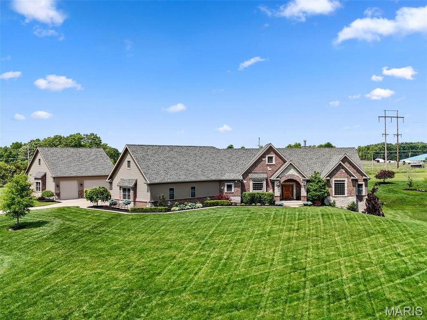 **Back on Market No Fault of Seller** Exceptional estate blending timeless elegance and modern luxury. The striking brick and stone exterior sets the tone, complemented by a detached garage with half bath and a resort-style inground pool surrounded by expansive patios and entertainment space. Inside, discover three exquisite bedroom suites on the main level, each offering privacy and comfort, along with a refined great room featuring a beautiful fireplace, main-floor laundry, and a covered patio for seamless indoor-outdoor living. The fully finished walk-out lower level includes an additional bedroom and full bath, spacious living and recreation areas, a custom bar perfect for entertaining, and a private office ideal for working from home. Every detail has been thoughtfully designed for refined living, comfort, and impressive functionality. Additional Rooms: Mud Room