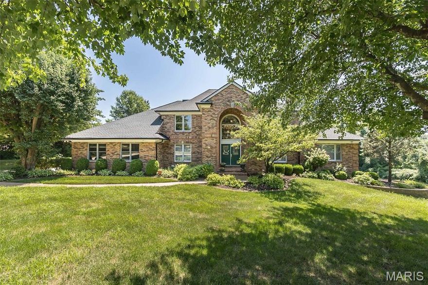 Prominently situated at the end of the cul-de-sac, this spectacular brick 1.5 Sty with its impressive 2-sty front porch & landscaped grounds makes a stunning entrance. Over 8,000 sq ft of living space enhanced by exceptional craftsmanship & extensive updates both inside & out including custom-designed kitchen & primary bath plus newer roof & HVAC & upgraded security system. Grand marble foyer flanked by dramatic double staircases leads to formal living & dining rooms, 2-sty great room with soaring windows, marble fireplace & wet bar and private study surrounded by natural wood paneling. Chef’s kitchen with 42” cherry cabinetry, granite countertops, premium stainless steel appliances & 7’ center island adjoins breakfast room with butler’s pantry & light-filled sun porch. Coffered primary bedroom suite combines the enjoyment of a marble fireplace with 2 walk-in closets & luxury bath with shower spa & jetted tub. Front & rear staircases access 4 additional bedrooms, loft sitting area & 2 full baths. The walkout Lower Level features entertainment space including a recreation room with fireplace, game room with wet bar, family room, office, 2nd kitchen, hobby room & 1.5 baths. Situated on a beautiful private 1.3-acre lot with deck, covered & open patios & 3-car garage. This cul-de-sac lot provides a perfect setting for adding pool & tennis court.