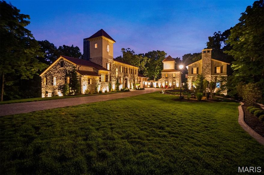 Centered on 13.4 acres and inspired by a tuscan village, this estate is a hidden masterwork.  in one of St. Albans’ most coveted enclaves. Designed to enchant, the residence offers 5 bedrooms, 6 full and 1 half baths, and 4 garage bays, effortlessly blending timeless Old World craftsmanship with modern indulgence. Dramatic stone walls, wide-plank and limestone floors, and custom alder cabinetry anchor the interiors with warmth and weight. The primary suite is a private retreat with a vaulted ceiling, cove lighting, a 20’ x 10’ dressing room, and a spa-caliber shower. A whimsical clock tower serves as a pub and bath for the Mediterranean-style heated saltwater pool and spa, while the carriage house provides a fully appointed guest apartment. Whether taking in treetop views from the third-floor observatory or experiencing the drama of the estate’s signature water feature, this home offers a living experience where comfort, character, and architecture converge effortlessly.