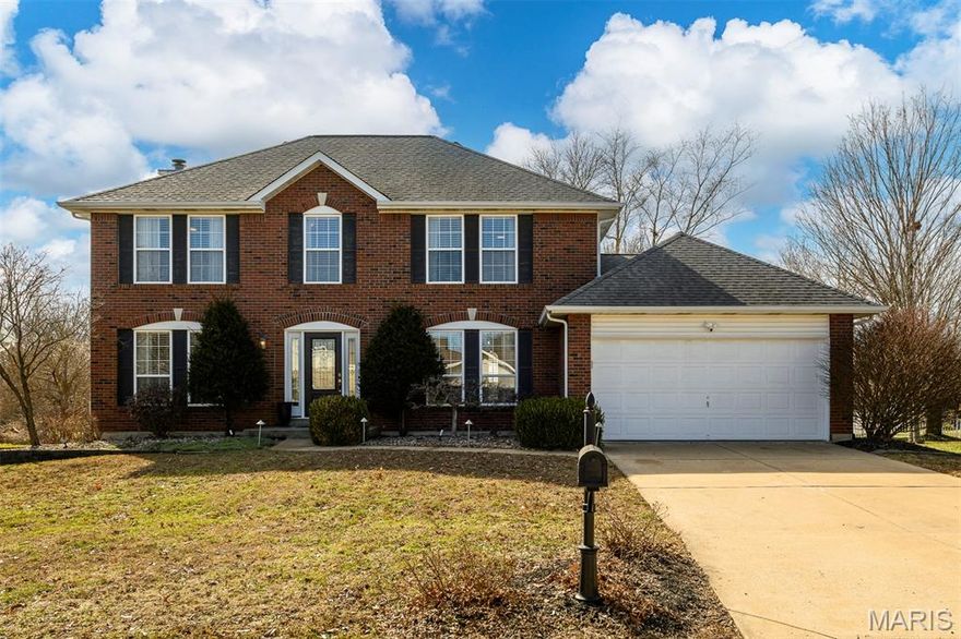 Move-in ready 2-story brick-front in sought-after St. Charles County! Elevated feel with gorgeous floors, crown molding, designer paint, new carpet, updated lighting, and bath fixtures. Main level flows effortlessly with formal dining (or a quiet escape), office/den, and a warm, inviting family room with bay window, gas fireplace, and custom built-ins. Kitchen hits the sweet spot between style and function with quality cabinetry, center island, granite counters, stainless appliances, and seamless access to a private patio and fully-fenced yard made for slow mornings, easy nights, and everything in between. Upstairs features a spacious primary suite with separate shower and jetted tub, plus three additional bedrooms. Updated main-floor laundry. Finished lower level adds flex space and a rare 4-person steam sauna, because you deserve it. Play in the cul-de-sac, or at the 3 pools, lakes, trails, clubhouse, & tennis. Timeless, comfortable, and the perfect amount of space to make everyone happy.