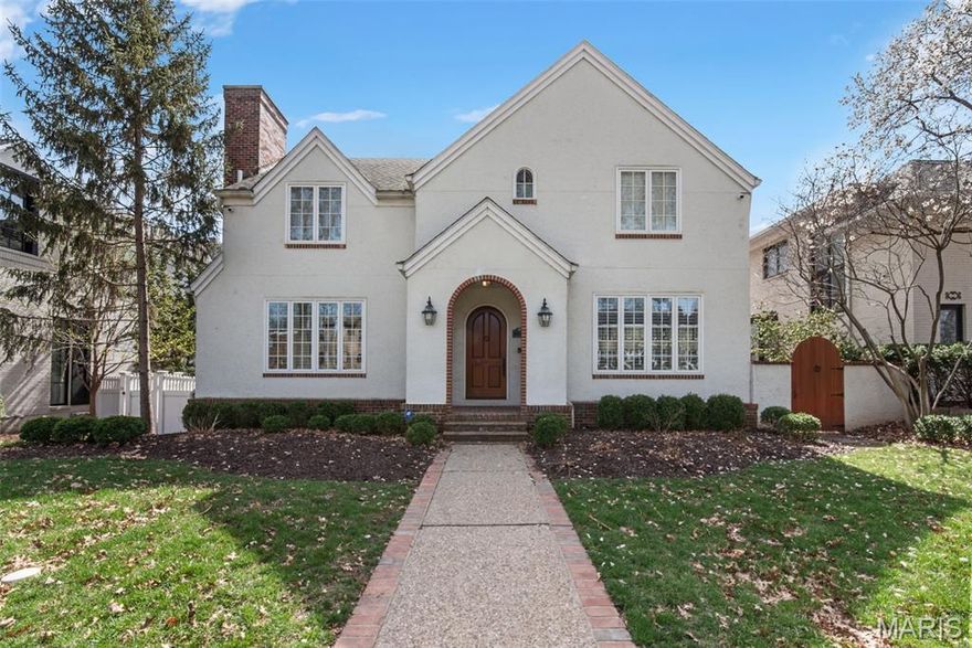 Set on a beautiful Clayton street, this architecturally striking estate offers refined living, exceptional craftsmanship, and the rare advantage of a private carriage house apartment. Deceptively spacious, the home unfolds well beyond its curb presence, with a layout that reveals generous living areas at every turn. The main residence features over 4,800 square feet with elegant formal and casual living spaces designed for both everyday comfort and sophisticated entertaining. A marble foyer with arched entry introduces richly detailed interiors including wide moldings, plantation shutters, and multiple gas fireplaces. The chef’s kitchen is beautifully equipped with a 6-burner Dacor range, Sub-Zero refrigerator, extensive cabinetry, and a fully appointed butler’s pantry with dual sinks and dishwashers—ideal for seamless entertaining. Just beyond the pantry, a mud room offers additional washer and dryer hookups, providing the option for convenient main-level laundry. Upstairs, the luxurious primary suite offers a private sitting room with coffee station, balcony, custom walk-in closet, and a spa-inspired bath with double-sided shower, jetted soaking tub, and separate water closets. Two additional en-suite bedrooms and convenient upstairs laundry complete the upper level. The walk-out lower level expands the living space with a wet bar, theatre room, gym area, guest bedroom, and full bath. A standout feature of the property is the detached 3-car carriage house garage with private apartment, offering exceptional flexibility for guests, extended family, an au pair suite, home office, or potential income opportunity. With timeless architecture, extensive amenities, and versatile living spaces, this Clayton residence presents a rare combination of elegance and functionality.