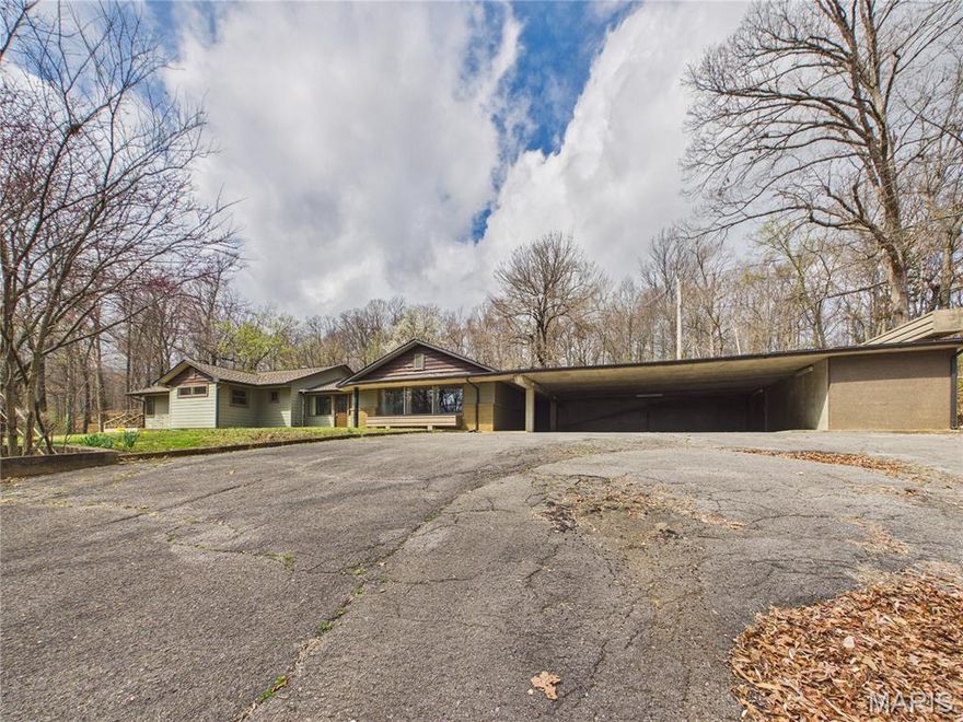 Tucked away at the end of a long, private drive, a unique opportunity awaits on nearly five acres of serene Missouri woodland. This isn't just a home; it’s a retreat designed for those who value both deep privacy and professional-grade utility. As you arrive, the first thing you’ll notice is the absolute quiet, with the property adjoining a lush, wooded landscape that ensures your peace remains undisturbed.

Step inside to find a thoughtfully updated residence that balances modern comfort with an open, inviting floor plan. While the two-bedroom, two-bathroom layout offers a cozy and contemporary living experience, the true heart of this home is a feature rarely found in a private residence: a fully equipped, commercial-grade kitchen. Outfitted with expansive stainless steel prep surfaces and professional ventilation, this space is a dream come true for the culinary enthusiast, a catering professional, or anyone who simply loves to host on a grand scale.

The story continues on the lower level, where a massive walk-out basement offers a blank canvas for your imagination. Currently serving as a powerhouse for storage and workspace, perfect for a home gym or an industrial-sized workshop, this area is ready to be finished into additional bedrooms or a secondary living suite to suit your growing needs.

Outside, the 4.83-acre lot provides a sanctuary for nature lovers, offering plenty of room to roam, garden, or simply enjoy the view from the deck. With an attached three-car carport and a wide paved turnaround, the property is as practical as it is beautiful, accommodating guests and equipment with ease.

Whether you’re looking for a secluded personal escape with character or a home base that can support your professional passions, this Dexter property offers a lifestyle that cookie-cutter homes simply cannot match.