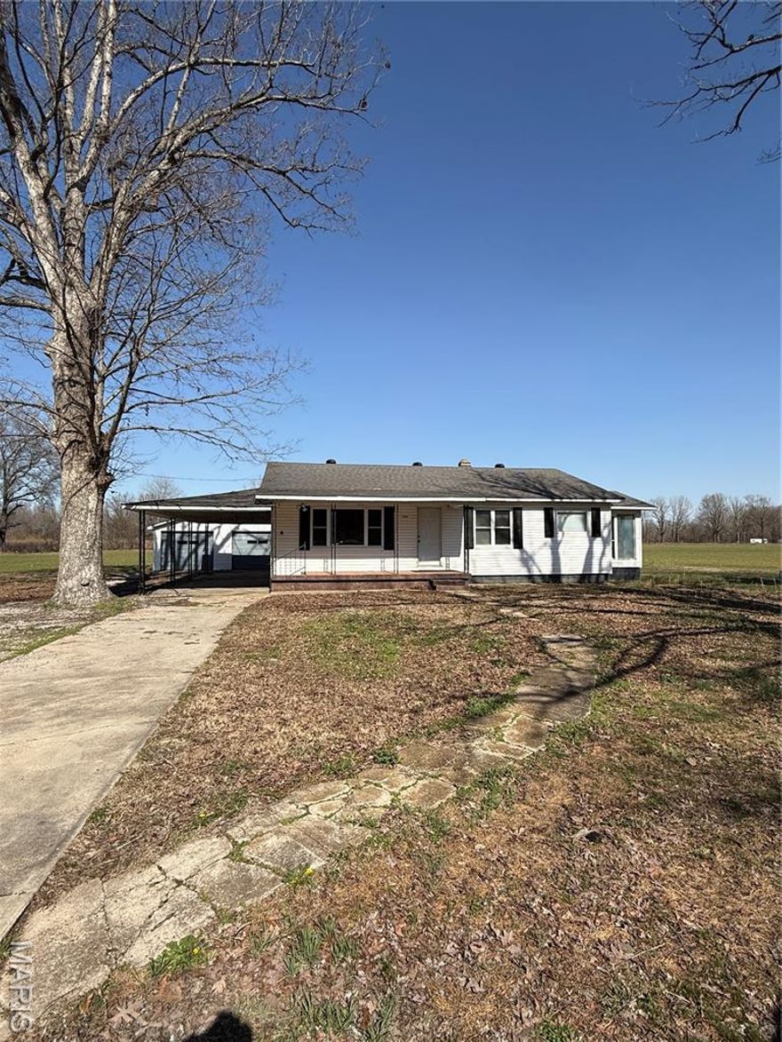 Just outside the city limits. Has been remodeled in the past. Lots of updates! The sunroom could be used as an additional bedroom or even an office. Agricultural field behind the home very scenic and private. The home has a 2-car carport as well as a 2-car garage.